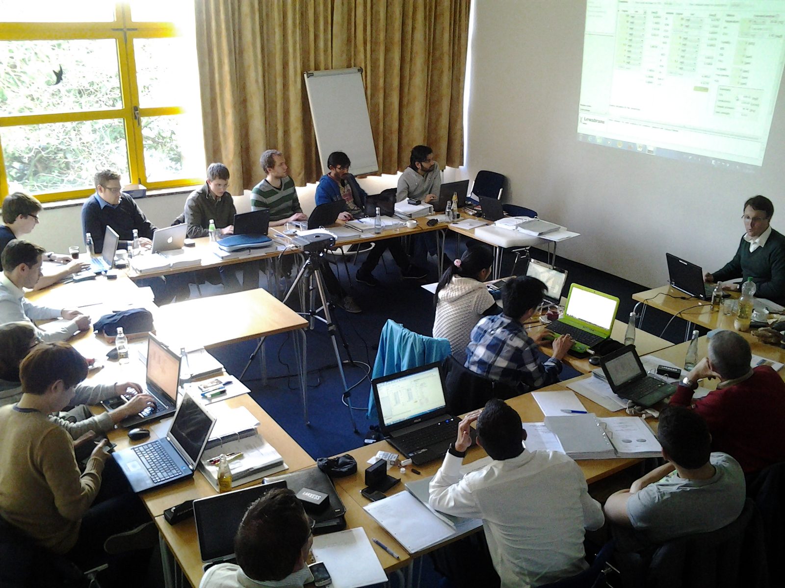 Training room where every participant works on a laptop with calculation software